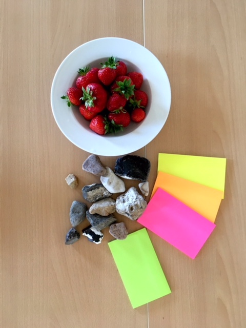 Strawberries, tomatoes, pebbles and paper